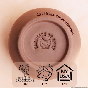 May include: A terracotta-colored ceramic bowl with the text "20 Chicken-Themed Designs." The bottom of the bowl is stamped with a chicken design and the words "HANDMADE BY EMILY." A sticker shows chicken illustrations and the text "EST. 2024 IRONSTONE L02."