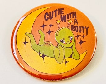 Cutie With A Booty - 2.25 inch pin back button / pocket mirror / magnet
