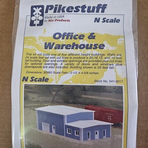 May include: A Pikestuff N Scale Office & Warehouse model building kit in a clear plastic bag. The packaging features blue and white text, a product image of a blue industrial building, and dimensions of 30x60 scale feet or 2-1/2 x 4-5/8 inches.