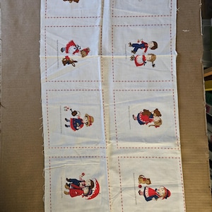 May include: A white fabric panel with six squares, each featuring a different illustration of children in various activities. The illustrations are in a vintage style and include a child riding a carousel horse, children playing with a bunny, children playing with a cat, children playing with a dog, children playing with a teddy bear, and children playing with a doll. The text in each square is in a red font and includes a short phrase about the activity.