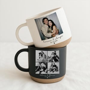 May include: Two ceramic mugs, one white and one black, stacked on top of each other. The white mug features a photo of a couple with the text "Forever & always" and a date. The black mug displays a collage of photos with names and a date.