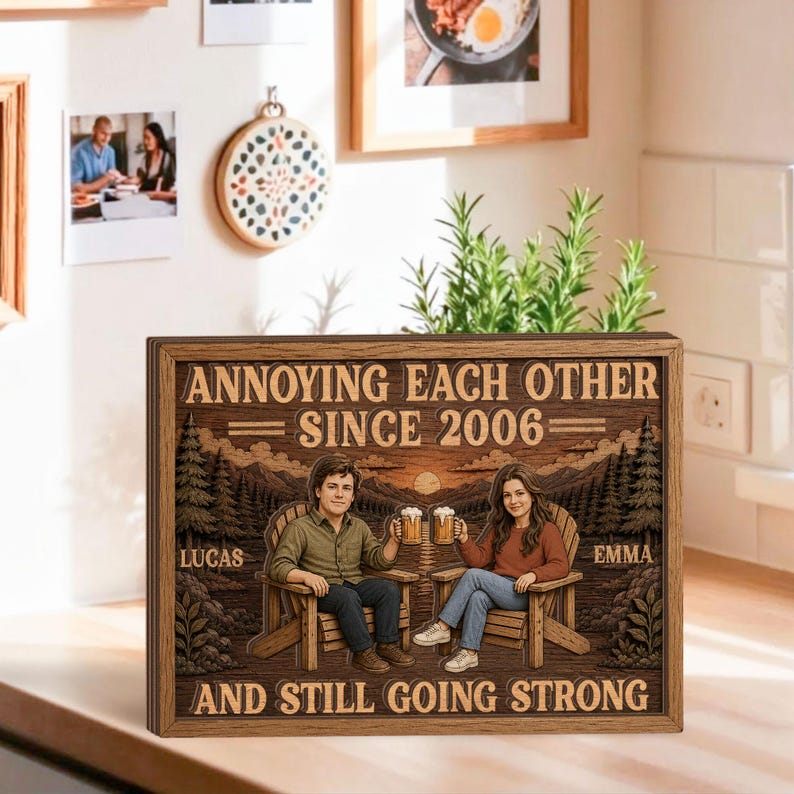 May include: A rectangular wooden sign featuring a laser-engraved illustration of two people sitting in chairs, each holding a beer mug. The text reads: ANNOYING EACH OTHER SINCE 2006, LUCAS, EMMA, AND STILL GOING STRONG, set against a forest background.