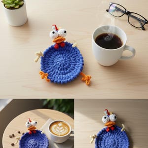 May include: A blue crocheted chicken coaster with white eyes, an orange beak, and yellow feet. The coaster is round and sits on a light-colored wooden surface. A cup of coffee and a small succulent plant are also visible.