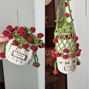 May include: Handmade crochet drink holders in white and green, adorned with red berry-like embellishments. One holder is a small basket, the other a net bag. Both have a "HANDMADE" tag.