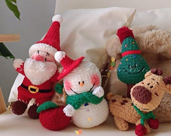 May include: A collection of handmade crochet Christmas ornaments. The set includes a Santa Claus, a snowman, a Christmas tree, a reindeer, and a red apple. Each ornament is made with soft yarn and features festive colors and details.