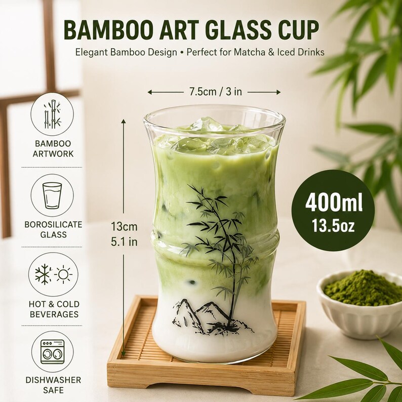 May include: A clear borosilicate glass cup with a bamboo-shaped silhouette, featuring a black ink illustration of bamboo stalks and mountains. The cup holds 13.5 oz, measures 3 inches in diameter and 5.1 inches in height, and contains a green matcha drink.