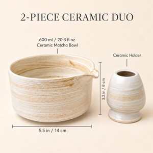 May include: A 2-piece ceramic duo featuring a 20.3 fl oz ceramic matcha bowl with a pouring spout and a ceramic holder. The bowl measures 5.5 inches in width, while the holder stands 3.2 inches tall. Both items have a cream and tan finish.