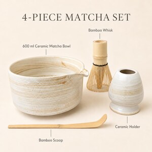 May include: A 4-piece matcha set featuring a 600 ml ceramic matcha bowl with a spout, a bamboo whisk, a bamboo scoop, and a ceramic holder. The items are labeled with text identifying each component of the set against a plain background.
