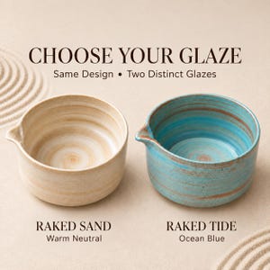 May include: Two ceramic bowls with a pouring spout, featuring the text CHOOSE YOUR GLAZE, Same Design &bull; Two Distinct Glazes. The left bowl is Raked Sand, a warm neutral, and the right bowl is Raked Tide, an ocean blue with brown streaks.