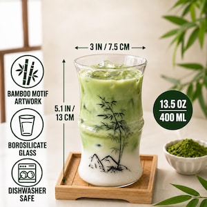 May include: A clear borosilicate glass shaped like bamboo stalks, filled with a green matcha latte and ice. The glass features a black bamboo motif, measures 3 inches wide by 5.1 inches tall, and has a 13.5 ounce capacity.