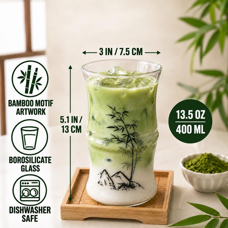 May include: A clear borosilicate glass shaped like bamboo stalks, filled with a green matcha latte and ice. The glass features a black bamboo motif, measures 3 inches wide by 5.1 inches tall, and has a 13.5 ounce capacity.