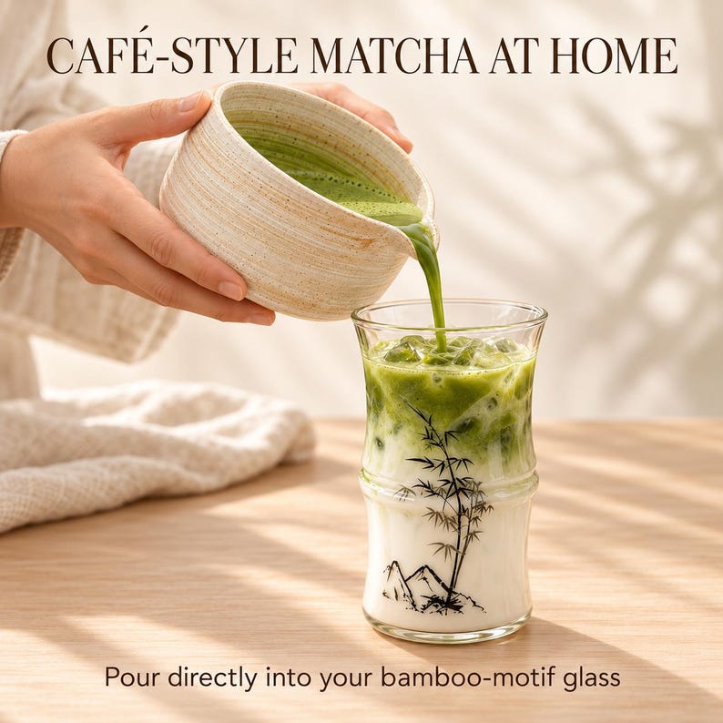 May include: A beige ceramic pitcher pouring vibrant green matcha into a clear glass tumbler featuring a black bamboo and mountain illustration. The text reads CAF&Eacute;-STYLE MATCHA AT HOME and Pour directly into your bamboo-motif glass.