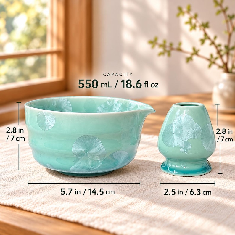 May include: A light green ceramic matcha bowl and whisk holder with white crystalline patterns. The bowl has a 550 mL / 18.6 fl oz capacity, a 5.7 inch width, and a 2.8 inch height. The whisk holder is 2.5 inches wide and 2.8 inches high.