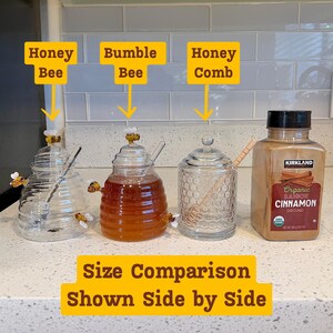 May include: A side-by-side comparison of honey jars and a cinnamon container. The jars are labeled "Honey Bee", "Bumble Bee", and "Honey Comb". The cinnamon container is labeled "Organic Saigon Cinnamon Ground". The text "Size Comparison Shown Side by Side" is also present.
