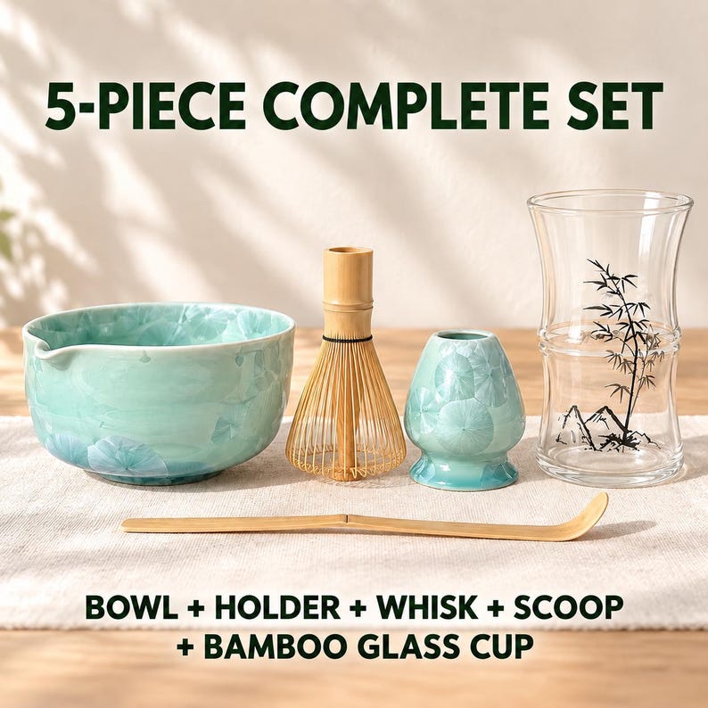 May include: A 5-piece matcha set including a light blue ceramic bowl, a bamboo whisk, a matching ceramic whisk holder, a bamboo scoop, and a clear glass cup with a black bamboo and mountain graphic. Text reads 5-PIECE COMPLETE SET and BOWL + HOLDER + WHISK + SCOOP + BAMBOO GLASS CUP.