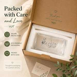 May include: A clear glass cup with a black bamboo illustration inside a brown cardboard box with white foam padding. The box lid features the text Packed with Care and Love, Thank you ENJOY YOUR TEA RITUAL, and a small card with Thank you Enjoy your tea ritual.