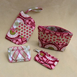 May include: Four different fabric pouches in pink, white, and green patterns. The pouches are made of cotton fabric and have a zipper closure. The pouches are perfect for storing small items like jewelry, coins, or keys.