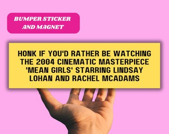 May include: Yellow bumper sticker or magnet with the text "HONK IF YOU'D RATHER BE WATCHING THE 2004 CINEMATIC MASTERPIECE 'MEAN GIRLS' STARRING LINDSAY LOHAN AND RACHEL MCADAMS"