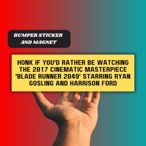 May include: A yellow bumper sticker or magnet with the text "HONK IF YOU'D RATHER BE WATCHING THE 2017 CINEMATIC MASTERPIECE 'BLADE RUNNER 2049' STARRING RYAN GOSLING AND HARRISON FORD".