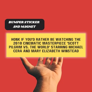 May include: A yellow bumper sticker and magnet with the text "HONK IF YOU'D RATHER BE WATCHING THE 2010 CINEMATIC MASTERPIECE 'SCOTT PILGRIM VS. THE WORLD' STARRING MICHAEL CERA AND MARY ELIZABETH WINSTEAD"