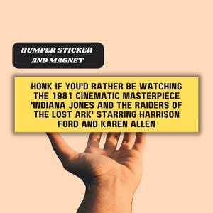 May include: Yellow bumper sticker or magnet with the text "HONK IF YOU'D RATHER BE WATCHING THE 1981 CINEMATIC MASTERPIECE 'INDIANA JONES AND THE RAIDERS OF THE LOST ARK' STARRING HARRISON FORD AND KAREN ALLEN"