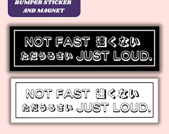 May include: Black and white bumper sticker or magnet with the text "NOT FAST 速くない ただうるさい JUST LOUD."