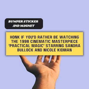 May include: Yellow bumper sticker or magnet with the text "HONK IF YOU'D RATHER BE WATCHING THE 1998 CINEMATIC MASTERPIECE 'PRACTICAL MAGIC' STARRING SANDRA BULLOCK AND NICOLE KIDMAN"