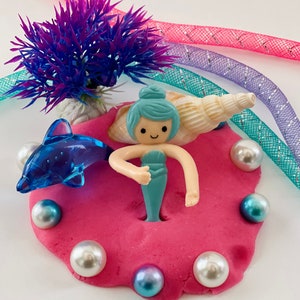 pink play dough with mermaid figurine and gems