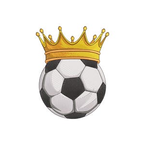 May include: A soccer ball with a black and white pattern, topped with a gold crown. The crown has multiple points and is detailed with small gold accents. The image is set against a clean white background.