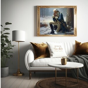 May include: A framed painting of a man in a military uniform kneeling in prayer in a snowy forest. The painting is in a gold frame and is hanging on a white wall above a white sofa with gold pillows.