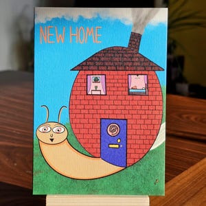 Funny New Home-kaart – Slakkenhuisvibes met alternatieve kunst – Raar, schattig en een nieuw begin, een feestje waard