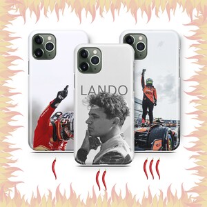 May include: Three white iPhone cases with different designs. The first case features a race car driver in a red and white racing suit. The second case features a black and white photo of a man with the word "LANDO" printed on the case. The third case features a race car driver in a blue and orange racing suit.