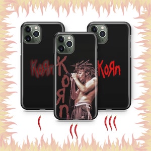 May include: Three black phone cases with a red Korn logo and a photo of a man with dreadlocks singing into a microphone. The cases are for different phone models.