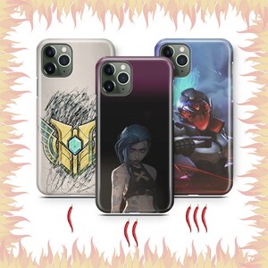 May include: Three different phone cases with various designs. The first case is black and white with a graphic of a character from a video game. The second case is black and white with a graphic of a character from a video game. The third case is blue and white with a graphic of a character from a video game.