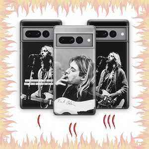 May include: Three smartphone cases featuring black and white portraits of Kurt Cobain. Two cases show him performing with a guitar and the text "JUST BECAUSE YOU'RE PARANOID DON'T MEAN THEY'RE NOT AFTER YOU." One case shows him smoking with his signature.