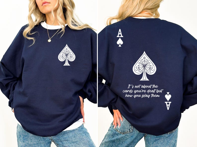 May include: A navy blue sweatshirt with a white ace of spades graphic on the front and back. The back graphic also includes the text "It's not about the cards you're dealt but how you play them."