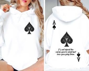May include: White hoodie with a black ace of spades graphic on the front and back. The text "It's not about the cards you're dealt but how you play them" is printed on the back.