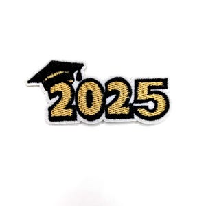 May include: Gold embroidered patch with the year 2025 and a black graduation cap.