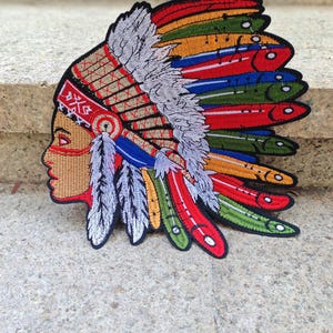 May include: A white ceramic mug with a black handle and the text "But First, Coffee" in a black, bold font. The mug is on a white surface.