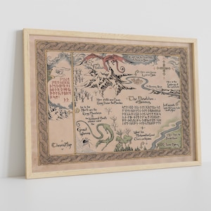 May include: A framed map illustration with a fantasy theme. The map features a dragon, mountains, and text in a stylized font. The color palette includes beige, brown, and green tones. The frame is a light wood color.