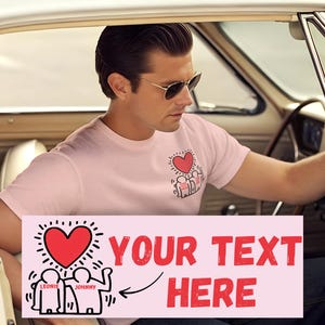 May include: Pink t-shirt with a graphic of three figures holding hands with a red heart above them. The text "YOUR TEXT HERE" is on a pink banner with a black arrow pointing to the graphic.