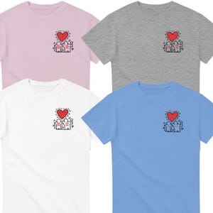 May include: Four t-shirts in different colors: pink, gray, white, and blue. Each shirt features a graphic of two figures holding a red heart with the word "LOVE" written inside.