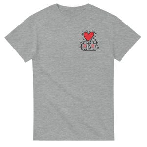 May include: A gray t-shirt with a black and red graphic of two figures holding hands under a red heart. The figures are wearing hats and the heart has a yellow halo.