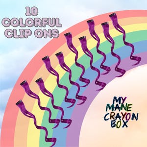 May include: Ten purple clip-in hair extensions arranged in a semi-circle on a rainbow background. The text "10 COLORFUL CLIP ONS" is at the top of the image. The text "MY MANE CRAYON BOX" is at the bottom of the image.