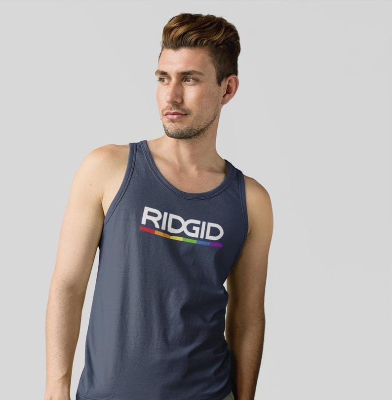May include: Navy blue tank top with the word "RIDGID" in white block letters. A rainbow-colored stripe underlines the text. The tank top is a sleeveless shirt made of a soft material.