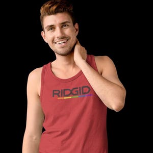 May include: A red tank top with the word "RIDGID" in black block letters and a rainbow stripe underneath. The tank top is sleeveless and made of a soft material.