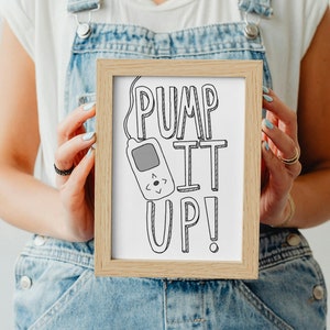 May include: A framed print with a white background and black line art of a cassette tape and the text "Pump It Up!"