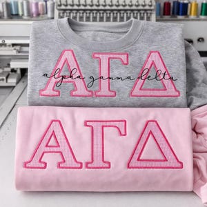 May include: A set of three ceramic mugs with a speckled, matte finish. Each mug features a different color: light blue, cream, and gray. The mugs have a simple, modern design and a comfortable handle.