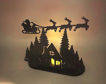 Christmas Tealight Display | Santa and his Reindeer Flying Over Cozy Woodland House