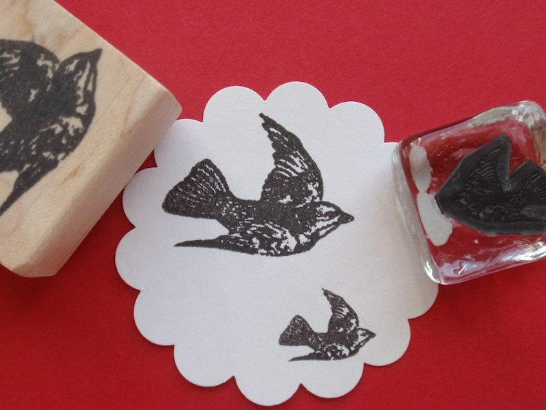 May include: Three rubber stamps featuring black silhouettes of birds on a white background. The stamps are mounted on wooden and glass blocks.